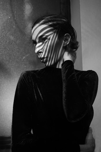 Woman in Black Long-sleeved Shirt Holding Her Neck