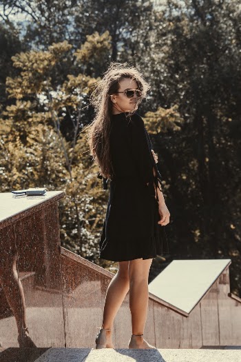 Woman in Black Mini Dress Standing on Stairs