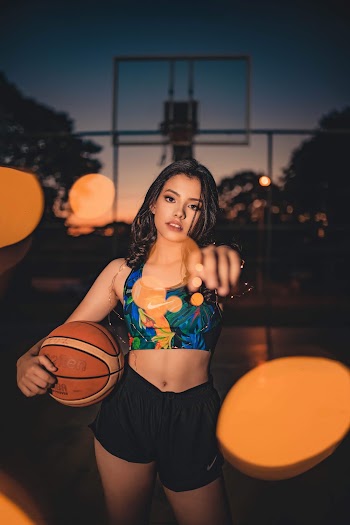 Woman in Black Nike Shorts Holding Basketball