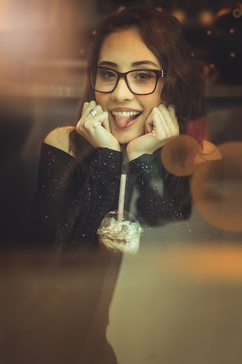 Woman In Black Off-shoulder Shirt And Black Framed Eyeglasses