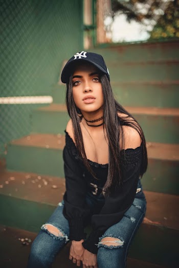 Woman in Black Off-shoulder Top and Cap