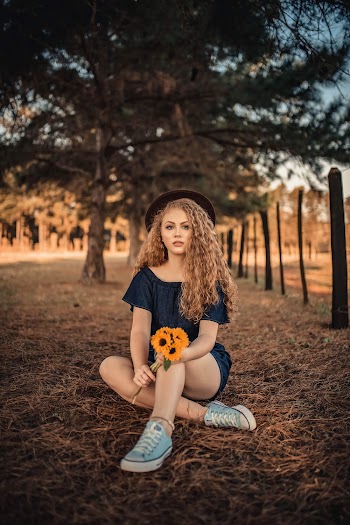 Woman in Black Off-shoulder Top Sitting on Ground
