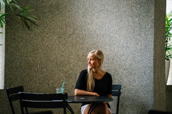 Woman in Black Scoop-neck Top Sitting on Black Metal Chair