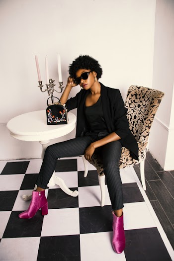 Woman in Black Shirt and Blazer Sitting on White and Brown Wooden Chair