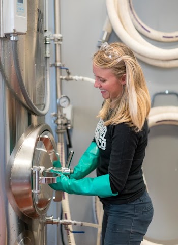 Woman in Black Shirt and Green Latex Gloves