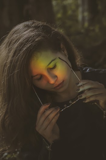Woman in Black Shirt Holds Sunglasses