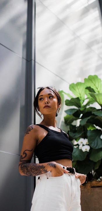 Woman in Black Sleeveless Crop Top and White Bottoms