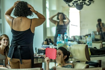 Woman In Black Spaghetti Strap Top Beside Woman Sitting Holding Pink Mirror