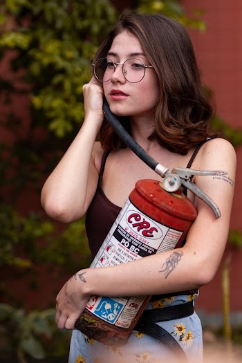 Woman in Black Spaghetti Strap Top Holding Fire Extinguisher