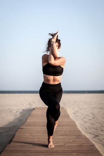 Woman in Black Sports Bra and Leggings Exercising in Docks