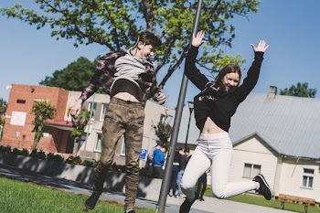 Woman in Black Sweatshirt and White Pants