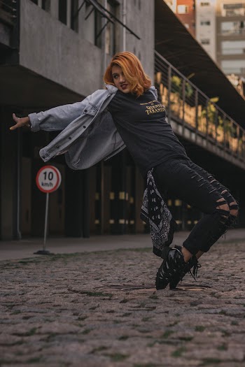Woman in Black T-shirt and Black Distressed Denim Jeans