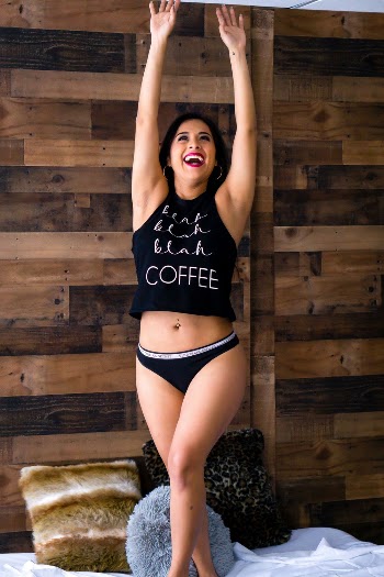Woman in Black Tank Top and Black Panties Standing With Both Arms Raised over Head