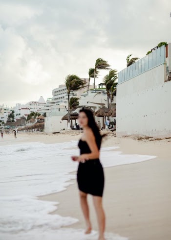Woman in Black Tank Top and Black Shorts Standing on Beach · Free Stock Photo