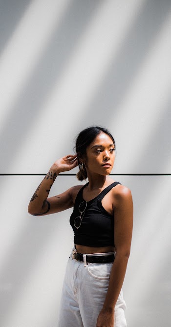 Woman in Black Tank Top and White Pants