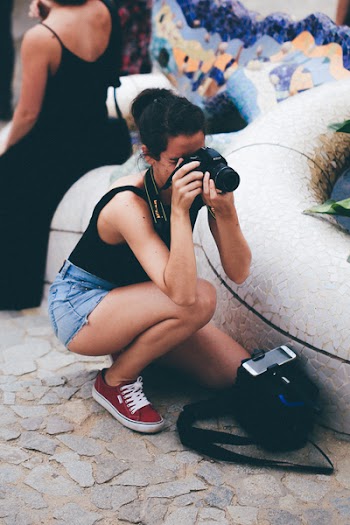 Woman in Black Tank Top Holding Dslr Camera
