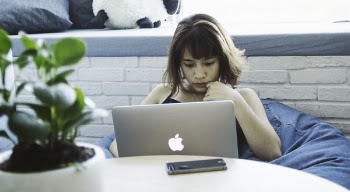 Woman in Black Tank Top Using Silver Macbook