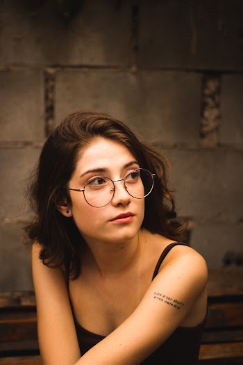 Woman In Black Tank Top Wearing Eyeglasses