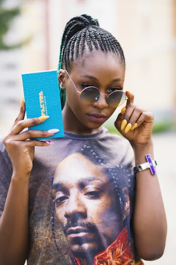 Woman in Black Tee Shirt Holding Blue Case