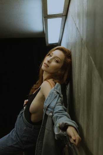 Woman in Black Top And Denim Pants And Jacket
