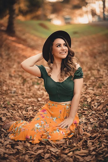 Woman In  Black Top and Orange Floral Skirt