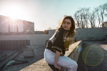 Woman in Black Top and White Pants
