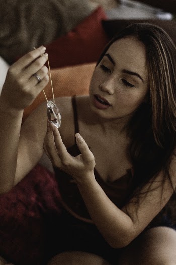 Woman in Black Top Holding Necklace