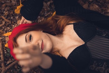 Woman in Black Top Lying on Ground