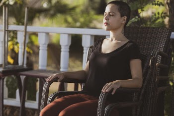 Woman in Black Top Sitting on Brown Armchair