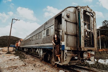Woman in Black Top Standing on Gray and White Train Door
