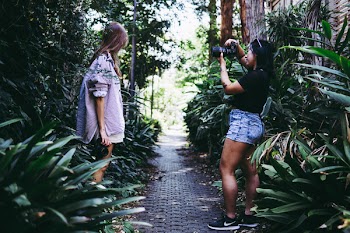 Woman In Black Top Taking Photo Of Another Woman 