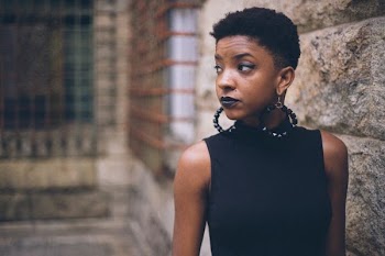 woman in black turtleneck top with earrings