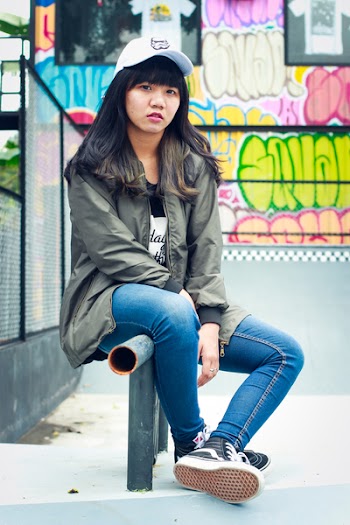 Woman in Black Zip-up Jacket Sit on Black Metal Rail