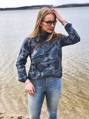 Woman in Blue and Gray Long-sleeved Shirt and Blue Denim Jeans Near Body of Water