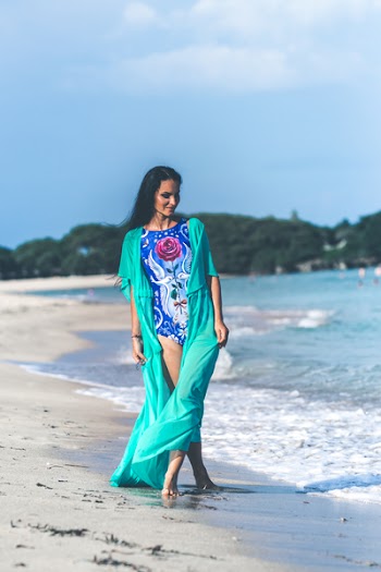 Woman in Blue and Pink Floral Monokini Standing at the Seashore