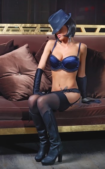 Woman in Blue Bikini Sitting Brown Sofa