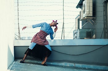 Woman in Blue Button-up Long-sleeved Top and Black Skirt