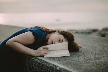 Woman in Blue Clothing With Opened Book 