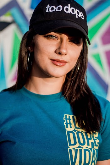 Woman in Blue Crew Neck Shirt Wearing Black Cap