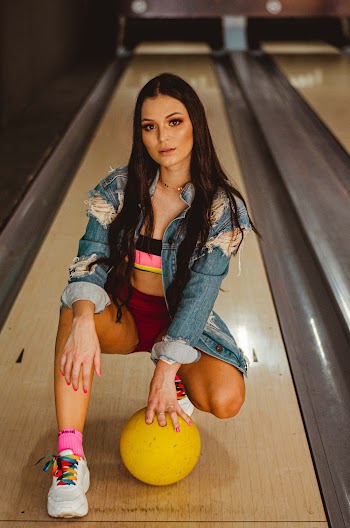 Woman in Blue Denim Jacket and Yellow Shorts
