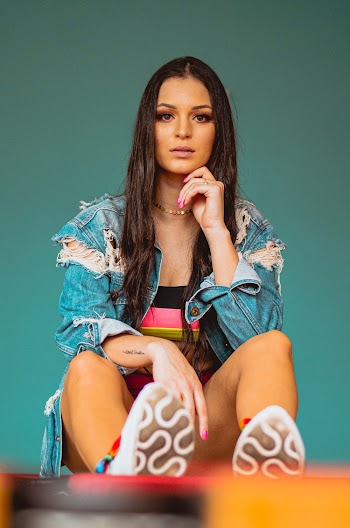 Woman in Blue Denim Jacket and Yellow Shorts