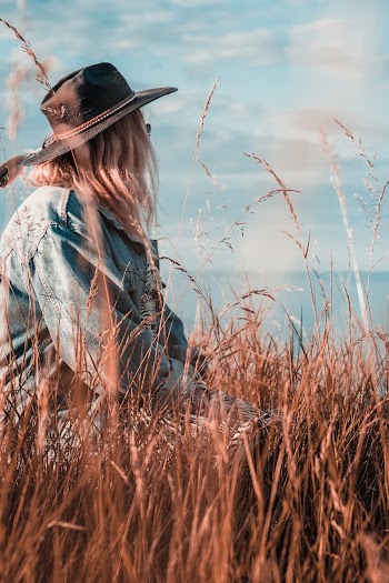 Woman in Blue Denim Jacket Facing Sideways Outdoors