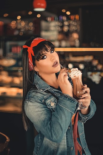 Woman In Blue Denim Jacket  Having A Drink