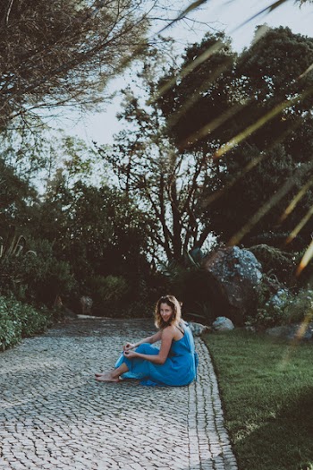 Woman in Blue Dress Sitting on Floor