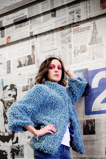 Woman in Blue Fleece Coat Standing Beside Board