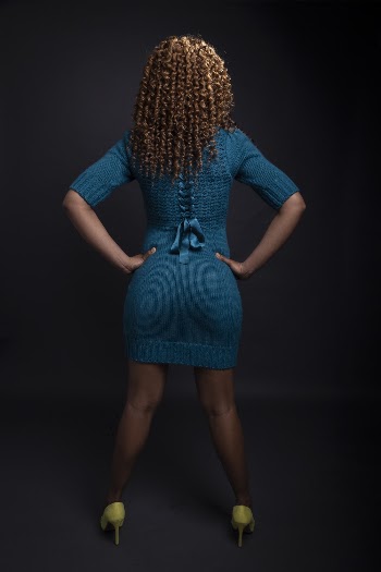 Woman in Blue Knit Dress Standing With Arms Akimbo