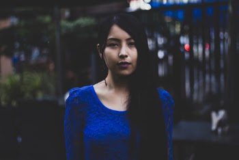 Woman in Blue Long-sleeved Top Standing Outside