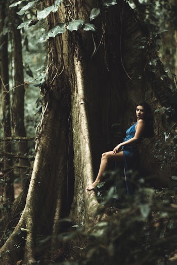 Woman in Blue Mini Dress Standing Beside Tree