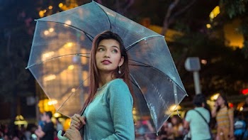 Woman in Blue Shirt Under Clear Umbrella