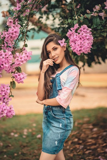 Woman in Blue Skirtalls Standing Beside Flowering Tree